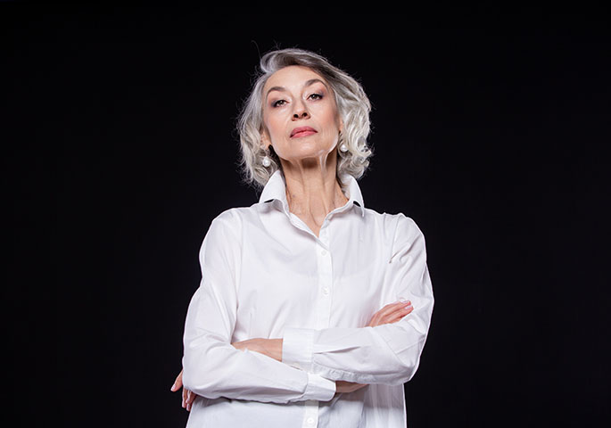 Woman with white shirt and folded arms.
