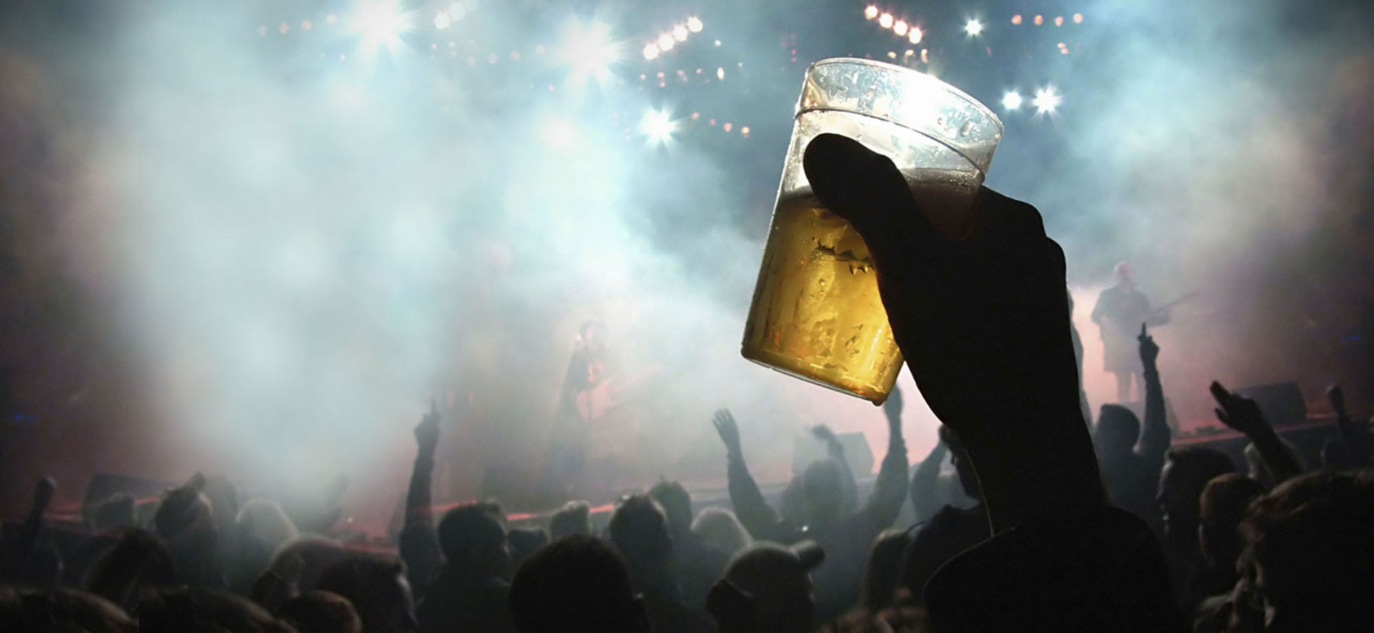Beer cup held up at rock concert.