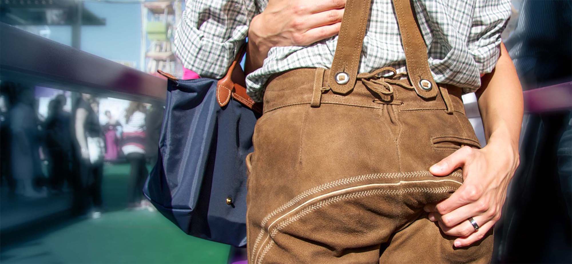 Woman grabs man's leather pants while hugging him